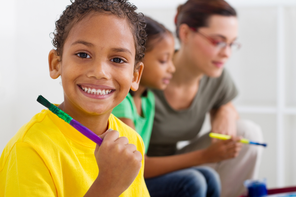 smiling boy with paintbrush